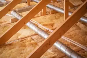 Attic insulation installation showing fiberglass batts